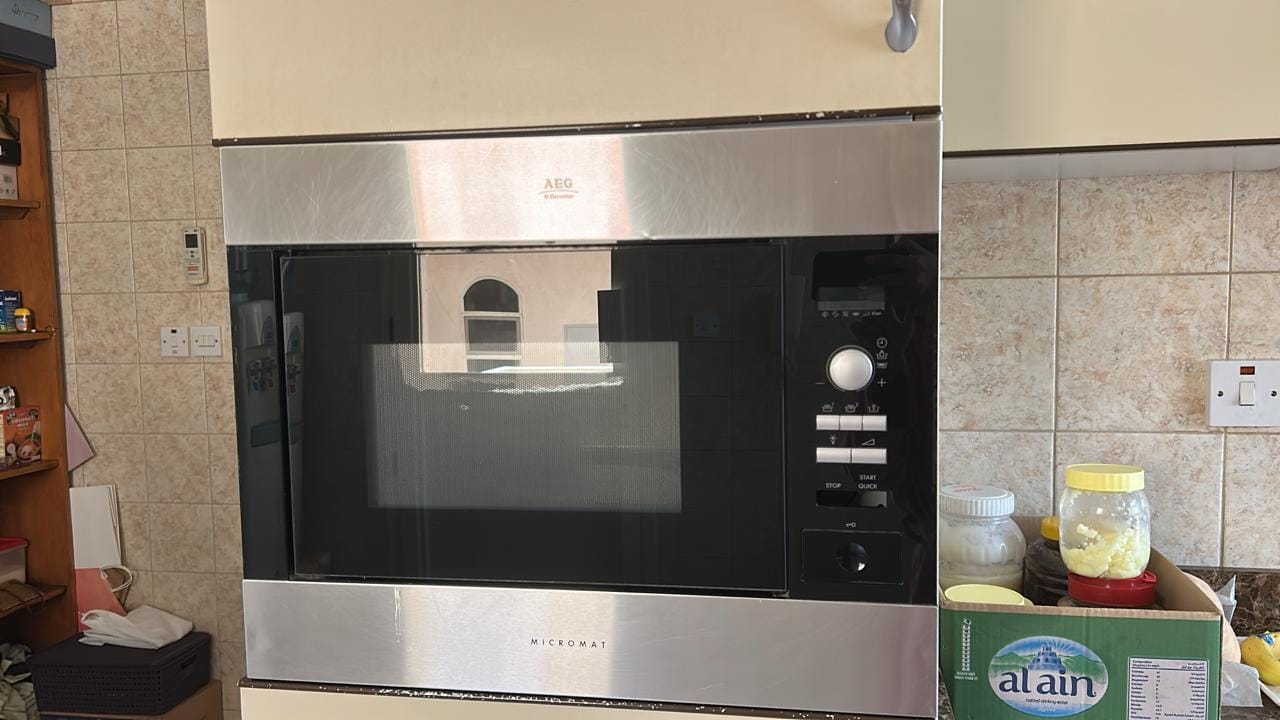 Built-in microwave in a kitchen column attended on a UAE service call