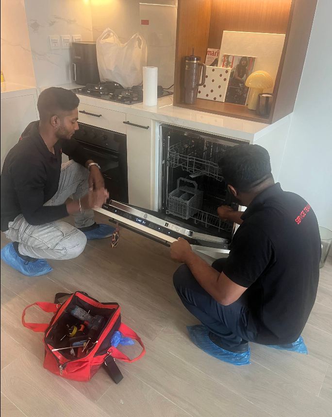 24x7 Customer Care service team completing a built-in dishwasher repair in Dubai