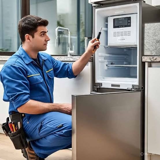Technician servicing a freezer thermostat and defrost control