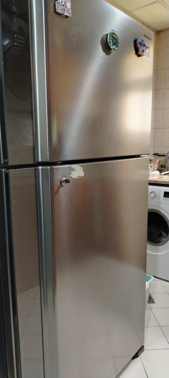 Multi-door refrigerator attended in a UAE apartment kitchen