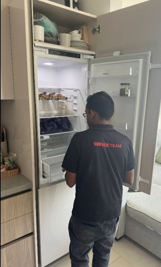 Uniformed service team technician arriving to inspect a built-in refrigerator in Abu Dhabi