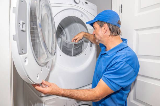 Technician cleaning the lint filter and airway of a tumble dryer